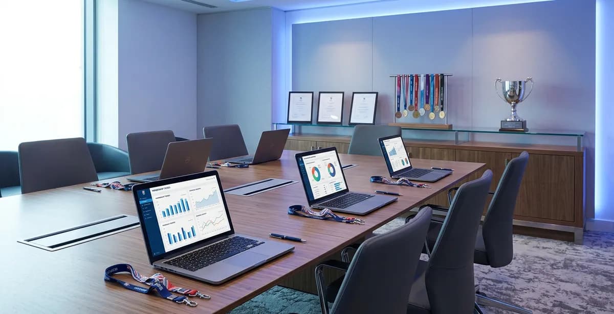 Sport governing body boardroom with AI strategy documents and governance planning materials