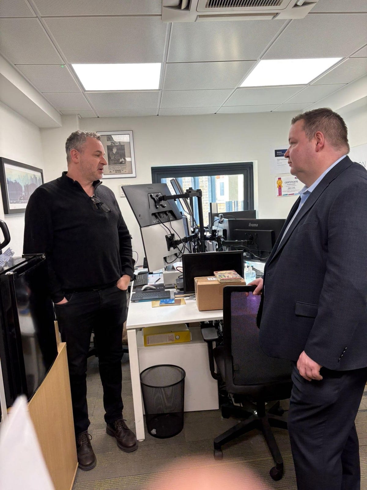 Craig Hartzel, Founder and CEO of Hartz AI, in conversation with Andrew Western MP, then Parliamentary Under-Secretary of State for Transformation at the Department for Work and Pensions, during a ministerial visit to the Hartz AI office at the Wohl Enterprise Hub, Finchley, London, on 28 April 2026.